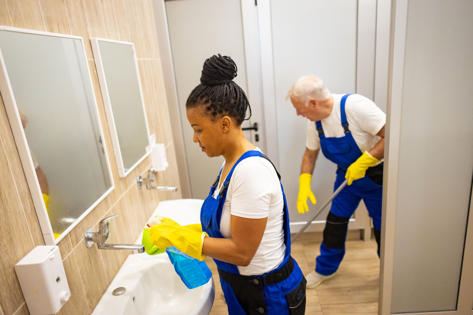 Colleague Janitors cleaning  school toilet